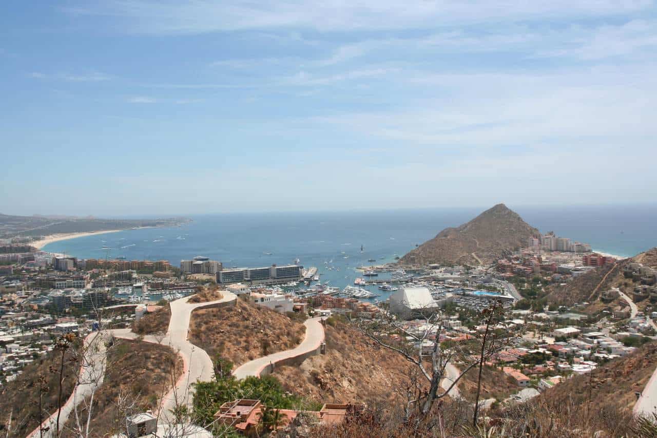 Pedregal Hillside View Overlooking Puerto Vallarta Bay With A Marina, Mountains, And Cityscape, Showcasing Luxury Real Estate Opportunities In Pedregal.