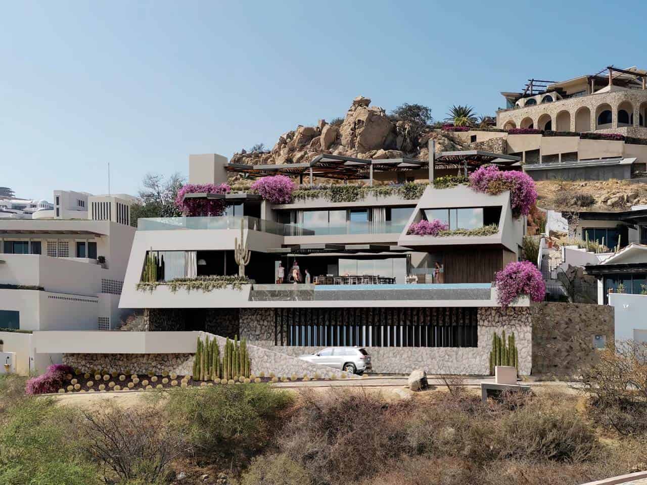 Modern Pedregal Luxury Home With Expansive Terraces, Desert Landscaping, And Vibrant Bougainvillea Flowers In A Hillside Setting In Pedregal.