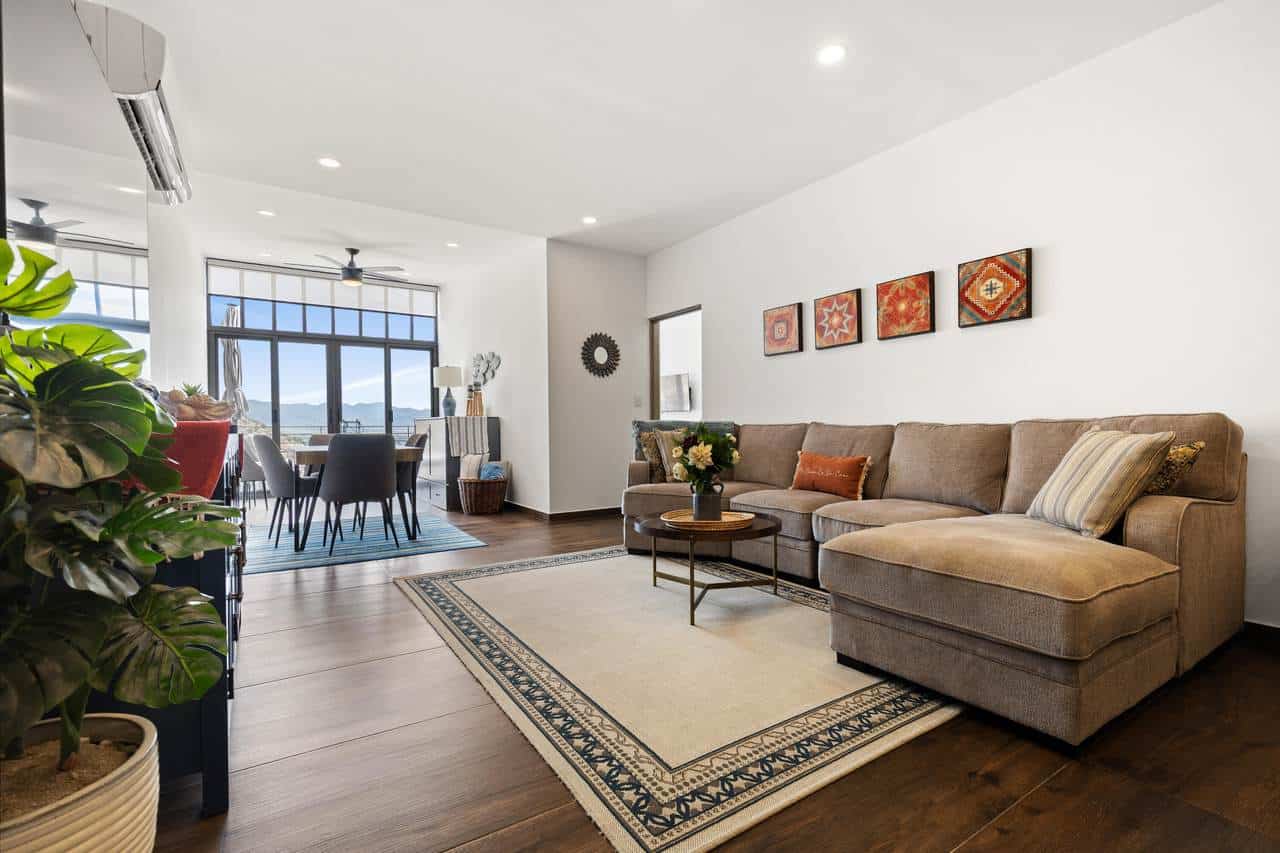 Spacious Pedregal Living Room With Modern Decor, Large Windows With Mountain Views, And Hardwood Floors, Perfect For Comfortable Living And Entertaining.