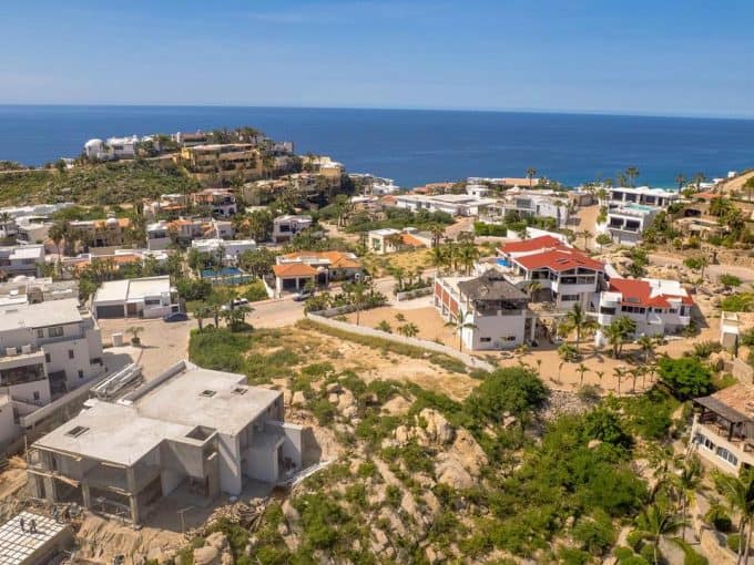 Stunning Aerial View Of Pedregal Real Estate With Luxurious Homes Overlooking The Ocean, Showcasing Modern Architecture And Scenic Coastal Views.